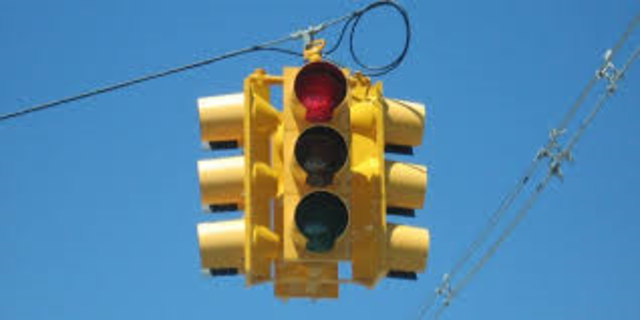 First three-colored four-way traffic lights