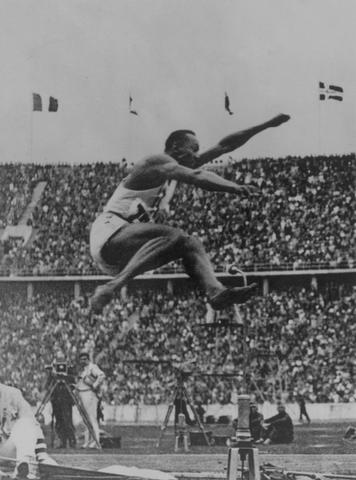 Jesse Owens wins four gold medals at Olympics in Germany