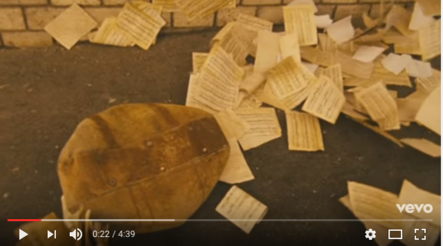 Prop of music sheets and bag being tossed by the wind