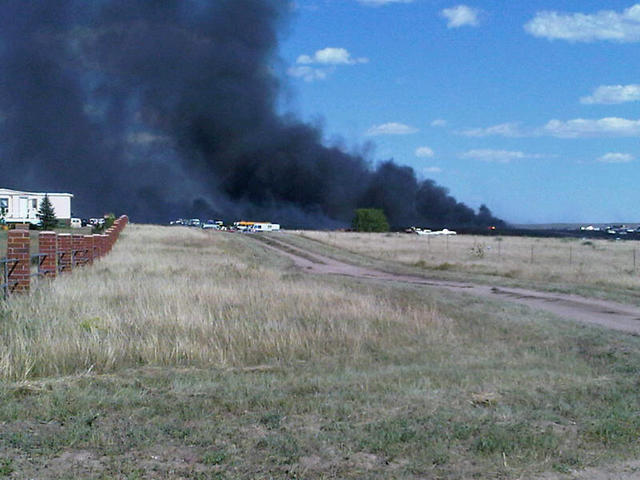 Wildfire burns cars, buildings near Peyton