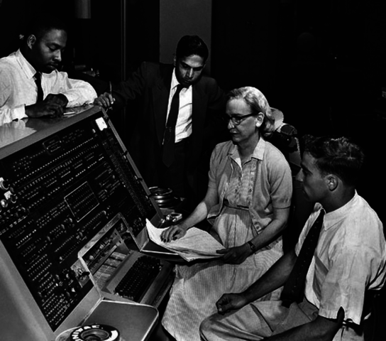 В 1954 году группа под руководством Г. Хоппер разработала систему, включающую язык программирования и компилятор, которая в дальнейшем получила название Math-Matic.