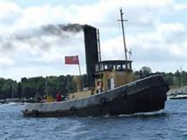 Tug towing barge caught fire