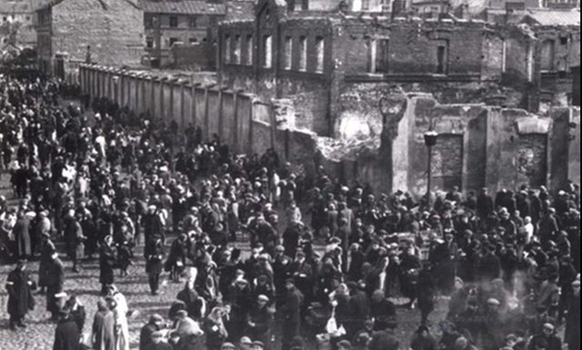 The Warsaw Ghetto reaches 500,000 inhabitants and is sealed off from the world