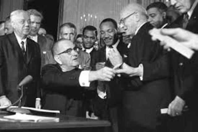 Johnson signs the Civil Rights Act of 1964.