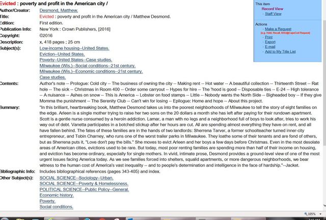 Student takes out a book with Cynthia's help