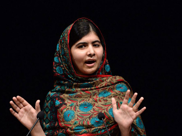 Malala is interviewed in front of many people