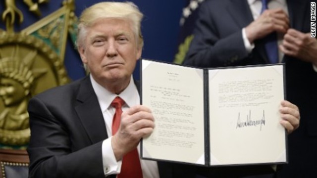 A. Trump signs Executive Order banning Muslim Refugees