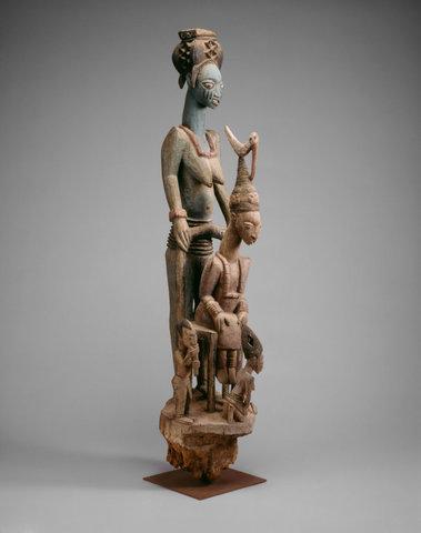 Veranda post of enthroned king and senior wife (Opo Ogoga). Olowe of Ise (Yoruba peoples). c. 1910-1914 C.E. Wood and pigment.