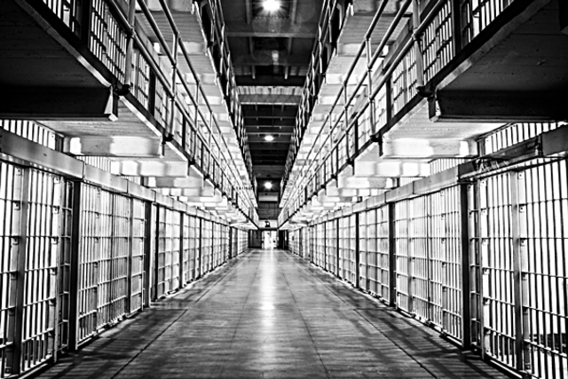 Malcolm starts educating himself by reading many books in prison.