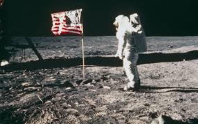 Astronauts walk on the Moon.