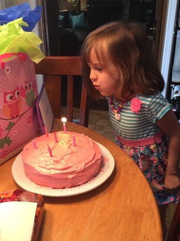 Sarah blows her candles out.