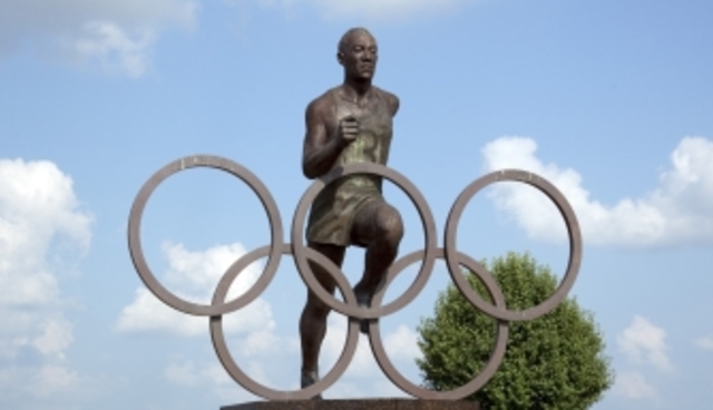 Jesse Owens wins four gold metals at Olympics in Germany