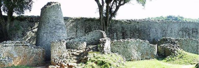 Conical tower and circular wall of Great Zimbabwe. Southeastern Zimbabwe. Shona peoples.Coursed granite blocks.