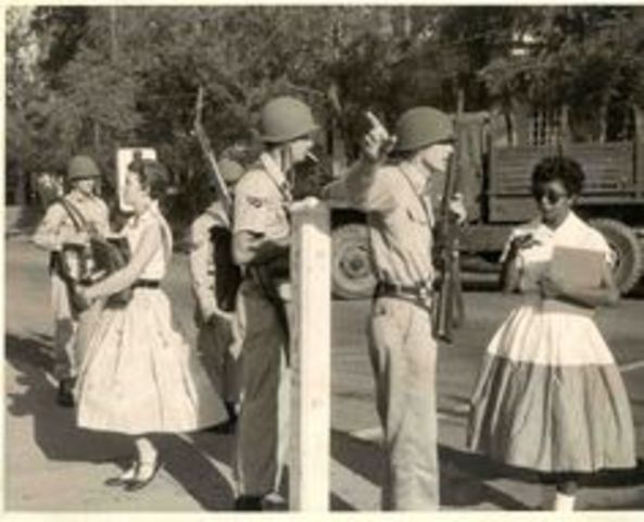 Soldiers block the black children from getting into the school