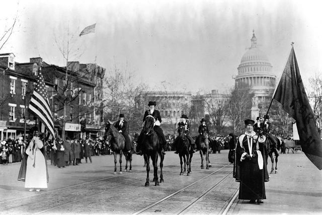 Alice Paul leads a march for suffrage in Washington DC