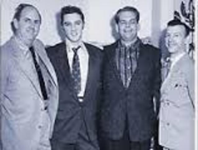 Elvis signs his first ontract