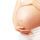 A pregnant women with both hands on her belly