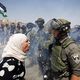 Palestinian woman argues with israeli border policeman west bank