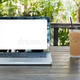 Laptop notebook iced coffee cup wooden table shop garden background 70003284