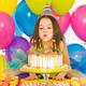Depositphotos 62105381 stock photo little girl blowing candles on