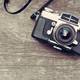 46638168 a vintage camera on wooden background