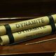 Dynamite stick isolated on wooden table 873415588 5abd8c2f3de423003671f6c3