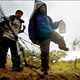 Illegal immigrants jumping border fence