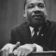 Martin luther king 1964 leaning on a lectern