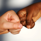 Black and white person fist bump