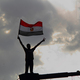Tahrir square cairo egypt revolution youth protest flag high dramatic sky 1
