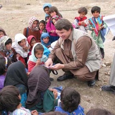 Timeline: Greg Mortenson's Journey. Scale: Afghanistan=Blue, Pakistan=Red, U.S.=Green, and Greg and his journey=Purple