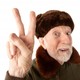 Russian man in fur cap making peace sign