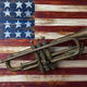 Old trumpet on american flag garry gay