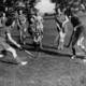 Women playing field hockey 194243