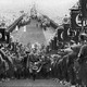 Hitler walking up steps at nazi rally