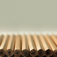 Row of plain pencils against grey background