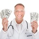 Shutterstock 201238628 1 doctor with money for surgicenter blog