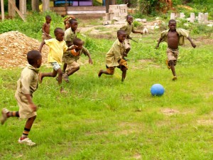 in Hohoe, Ghana, young boys chase the One World Futbol.