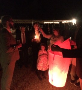 Bride and groom, Chelsea and Bobby Losh Jones, toast the pending launch of their wish balloon. Credit: David Pendered