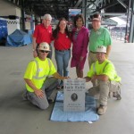 Lynne Falls Shriber (in red shirt) received help from Bill Liss of WXIA and the Ironworkers in retrieving the granite marker for her brother. Its future was in doubt because the Braves will leave Turner Field after the 2015 season for a new ballpark in Cobb County. (Photo courtesy of Jackie Falls)