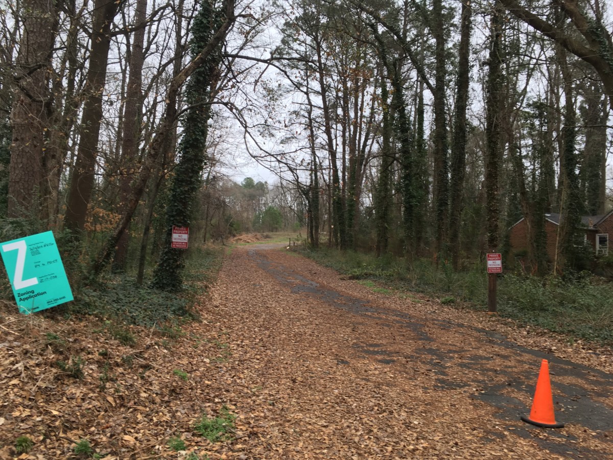 Fall leaves still lie on Thress Street, which dead-ends into Ormewood Forest in southeast Atlanta. A sign announces a request to rezone the area. Credit: Maggie Lee