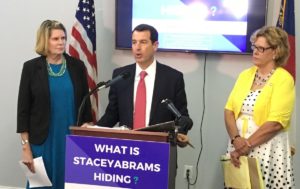 Georgia GOP Chairman John Watson flanked at Cobb party headquarters last week flanked by high-ranking state lawmakers Jan Jones (l) and Renee Unterman. Credit: Maggie Lee