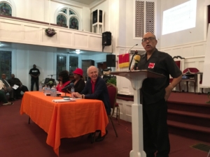 Former state Senator Vincent Fort speaks at a teach-in to "redlight the Gulch." At the table, other Gulch deal opponents, from left: community organizers and activists Sharise Brown and Tanya Washington; and former Invest Atlanta board member Julian Bene. Credit: Maggie Lee