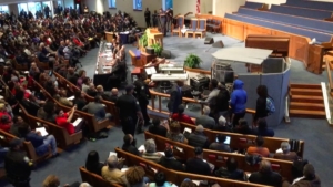 Several people leading a chant calling out the name of Jimmy Atchison, shot by an Atlanta police officer who's now under investigation. Credit: Maggie Lee