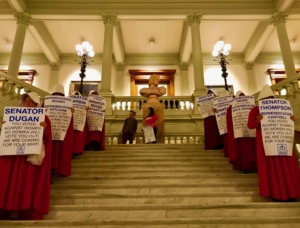 A file photo from March shows what was a common site at the Capitol this year: people protesting 481, dressed as women from The Handmaid's Tale, a book set in a theocratic America that subjugates women completely. Credit: Kelly Jordan