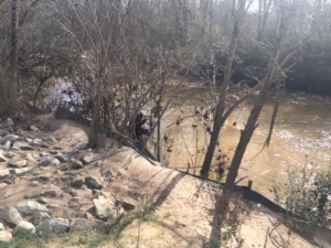 A silt fence keeps some of the dirt out of Intrenchment Creek. But the fight against pollution is ongoing in south DeKalb's waterways. Credit: Jacqueline Echols