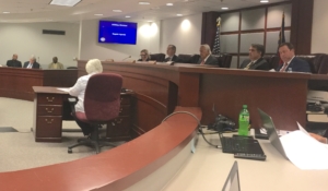 Public Service Commission members sitting in hearing on July 16
