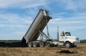 A typical application: a truck delivering biosolids to a field of stubble. Credit: City of Geneva/CC BY-NC 2.0
