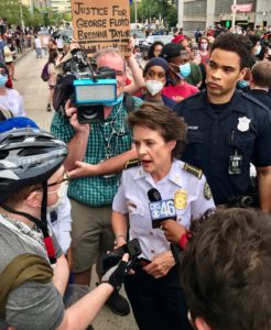 Atlanta Police Chief Erika Shields in a crowd of reporters and protestors