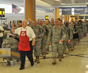 vietnam veteran Tony Hilliard, member of the Atlanta Vietnam Veterans Business Association, volunteers to help troops traveling through Atlanta's airport. Hilliard's group is known for serving hotdogs with chili and all the fixings.